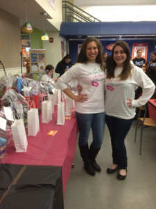 Ashley Higgins, a sister of Phi Sig (left) and the event coordinator, Kaie McNamara (right) in front of the prize table (Photo by Francesca Fontanez) 