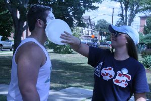 A sister of Delta Phi Epsilon pies a brother of Sigma Chi in the face to raise money for the fraternity’s philanthropy (Photo by Jaime Graden/Charger Bulletin photo)