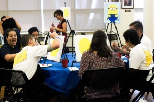 Families painting Minions in the Alumni Lounge (Photo by Sam Reposa/Charger Bulletin photo)