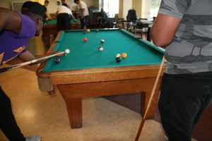 Students playing pool in the Bergami Game Room  (Photo by Ashley Wemmell/Charger Bulletin photo)