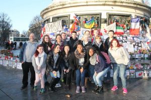 The students at the Bastille, after the market day, in front of the tributes to peace/victims of the terrorist attacks (Photo provided by Alyssa MacKinnon)