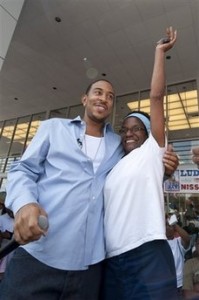 Rapper Ludacris smiles as Ella Me Johnson reacts to being presented with keys to her car at Nissan South, Sunday, Sept. 6, 2009.