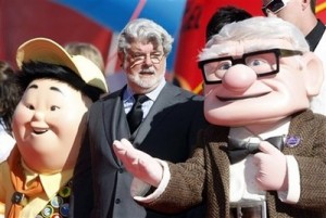 Film director George Lucas flanked by characters from animated movie upon arrival for the presentation of the Golden Lion for life-time achievements.
